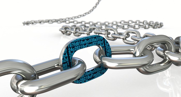 Closeup rendering of a steel chain where one link is covered in digital data.